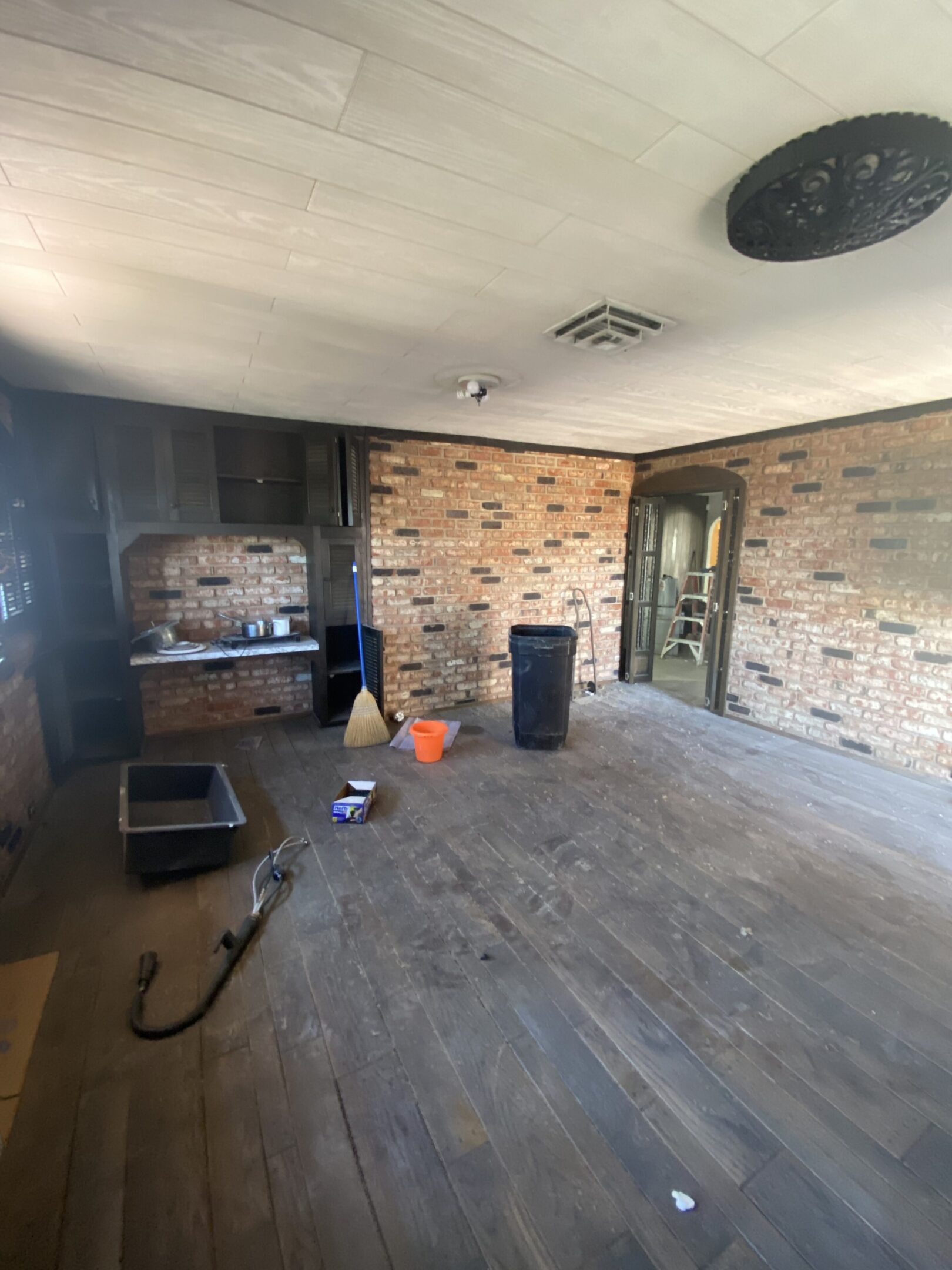 Room under renovation with exposed brick wall