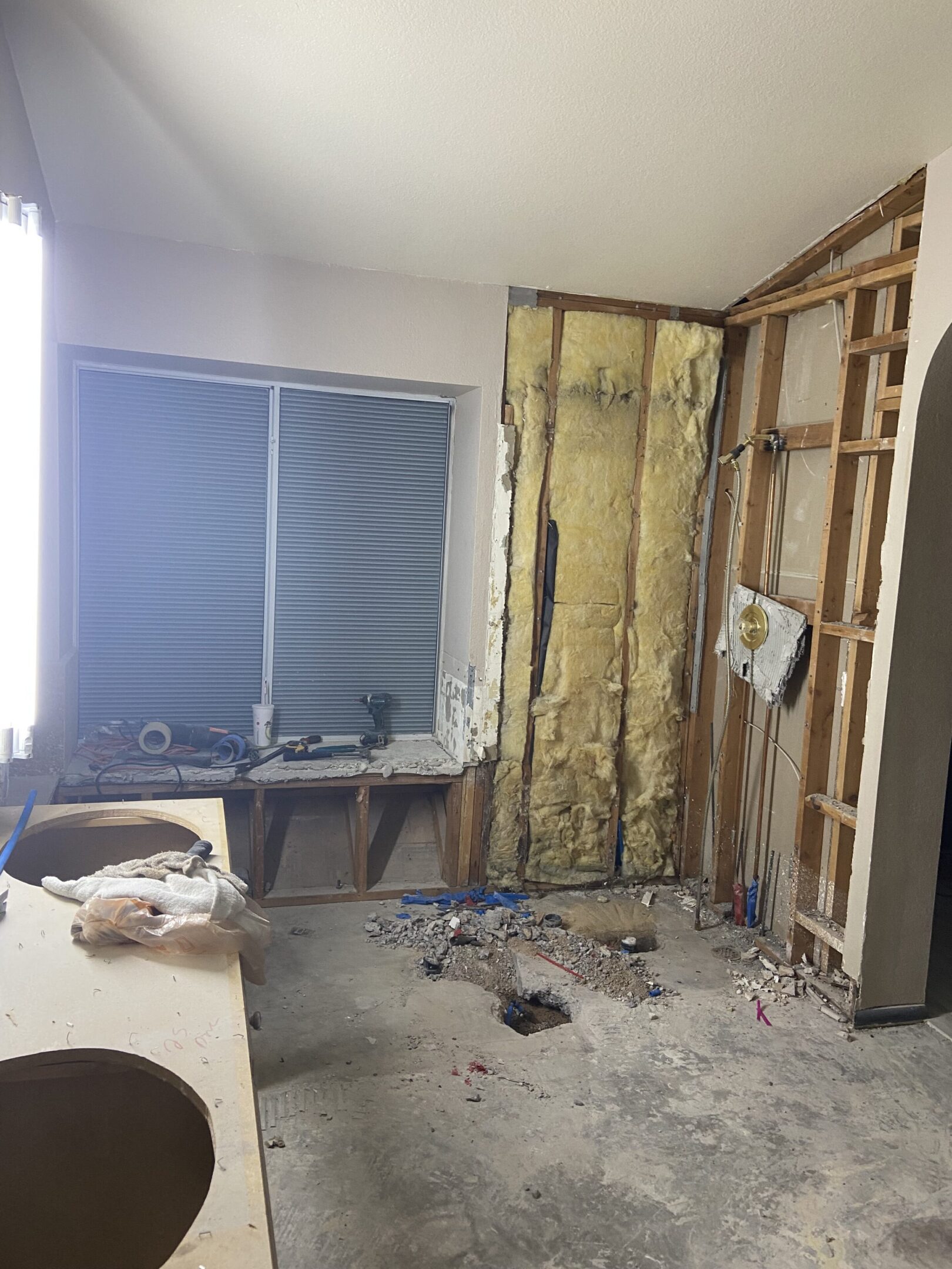 Bathroom under renovation with exposed insulation