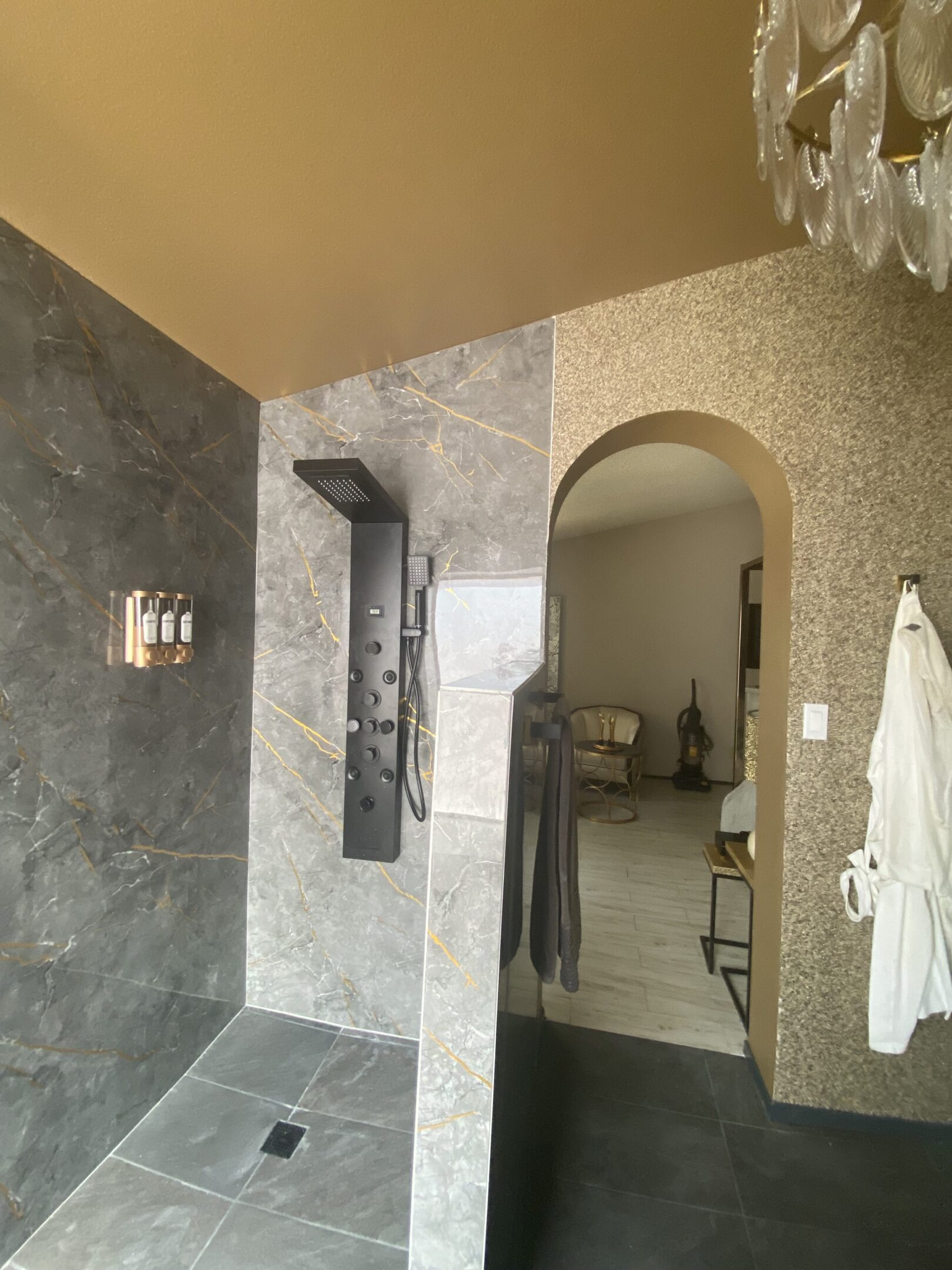 Modern tiled shower with black panel