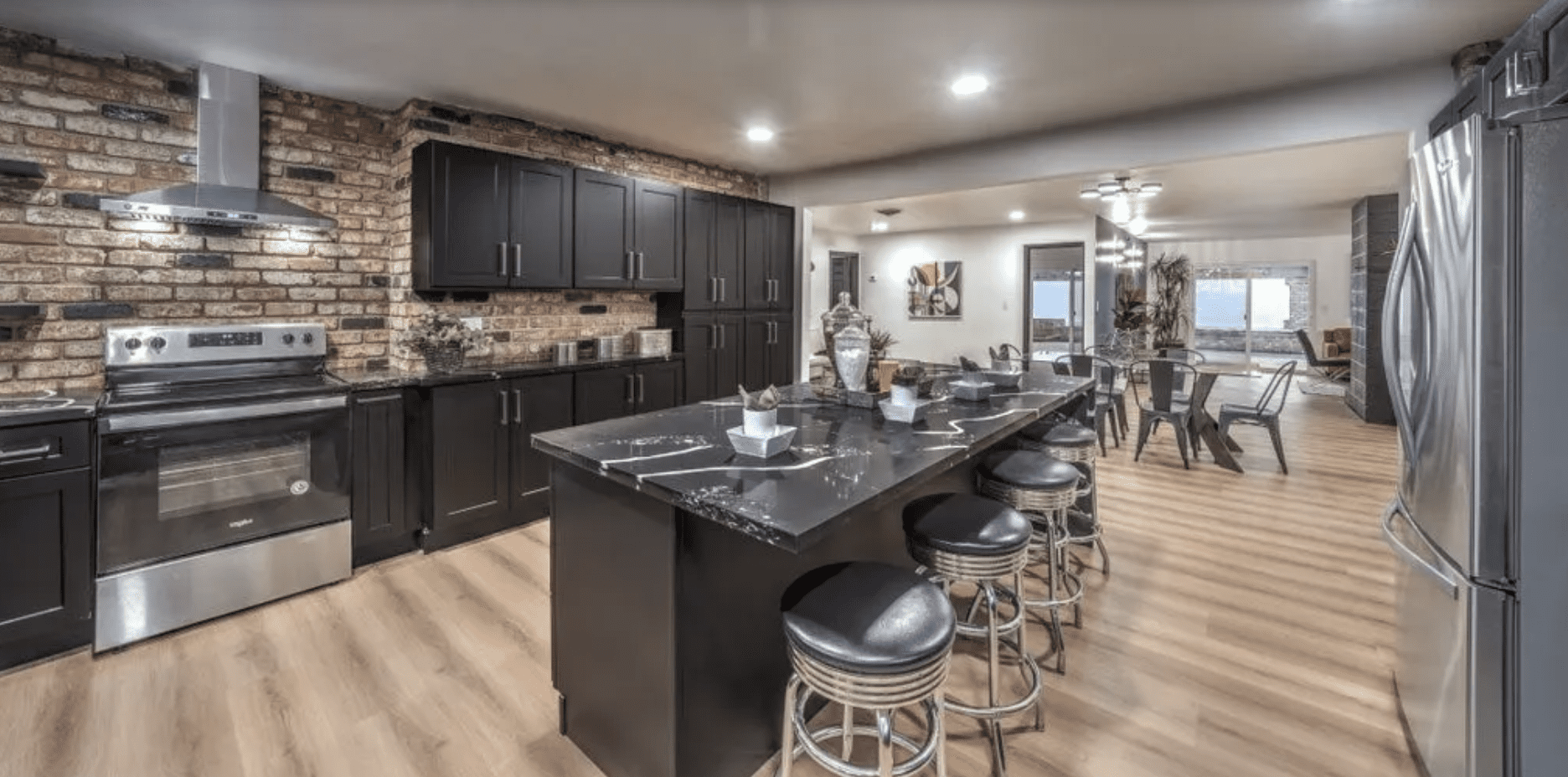 Modern kitchen island with barstools and exposed brick